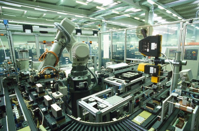 Robot assembling electronic components --- Image by &copy; Michael Rosenfeld/Maximilian S/SuperStock/Corbis